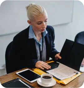 A Financial industry women reading a file and having a cup of black coffee. A Financial industry women reading a file and having a cup of black coffee.